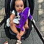 baby, black_car_seat, car_seat, child, clothing, cute, feet, foot, hand, happy, infant, outdoor, pavement, person, plush_toy, purple_toy, sandals, seatbelt, skin, stroller