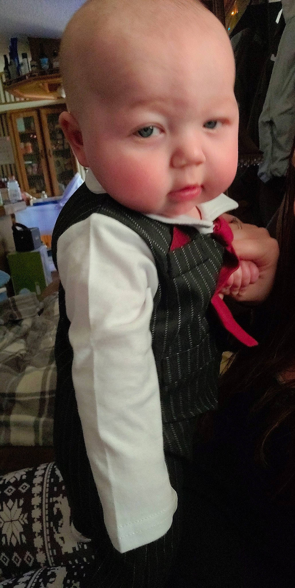 Cain is registered to the contest to win money with this photo: baby, baby_toddler_clothing, bookcase, button, cheek, child, linens, lip, person, plaid, shelf, shelving, skin, tablecloth, tartan, textile, thumb, toddler