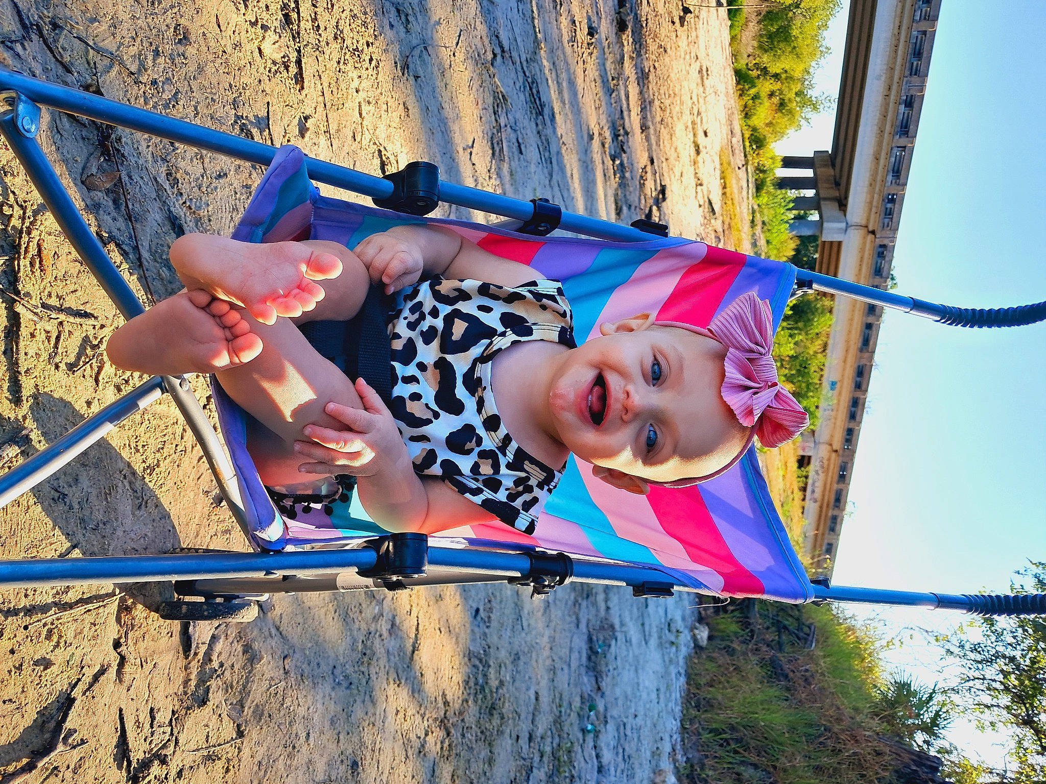 Amanda is registered to the contest to win money with this photo: child, city, elbow, electric_blue, fun, happy, joy, leisure, nature, outdoor_play_equipment, person, play, playground, recreation, sky, smile, summer, swing, thigh, toddler