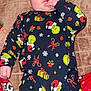 baby, infant, pajamas, grinch, holiday, christmas, blanket, hand, face, sucking, cozy, lying_down, child, cute, festive, red, green, patterned_clothing, indoors, soft
