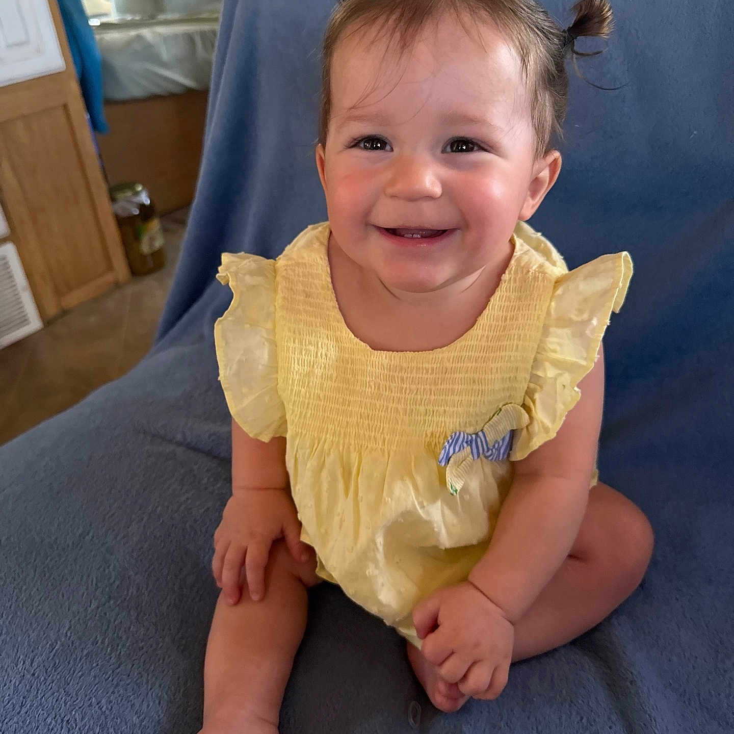 Moncerat joined the competition — help win amazing prizes! baby, blanket, child, cozy, cute, face, foot, furniture, hand, happy, home, indoor, infant, person, pigtails, portrait, sitting, skin, smiling, yellow_dress