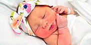 Presley is registered to the contest to win money with this photo: baby, baby_sleeping, cheek, child, fashion_accessory, forehead, hair_accessory, hand, head, headband, headgear, headpiece, lip, nose, photography, pink, product, skin, sleep, toddler