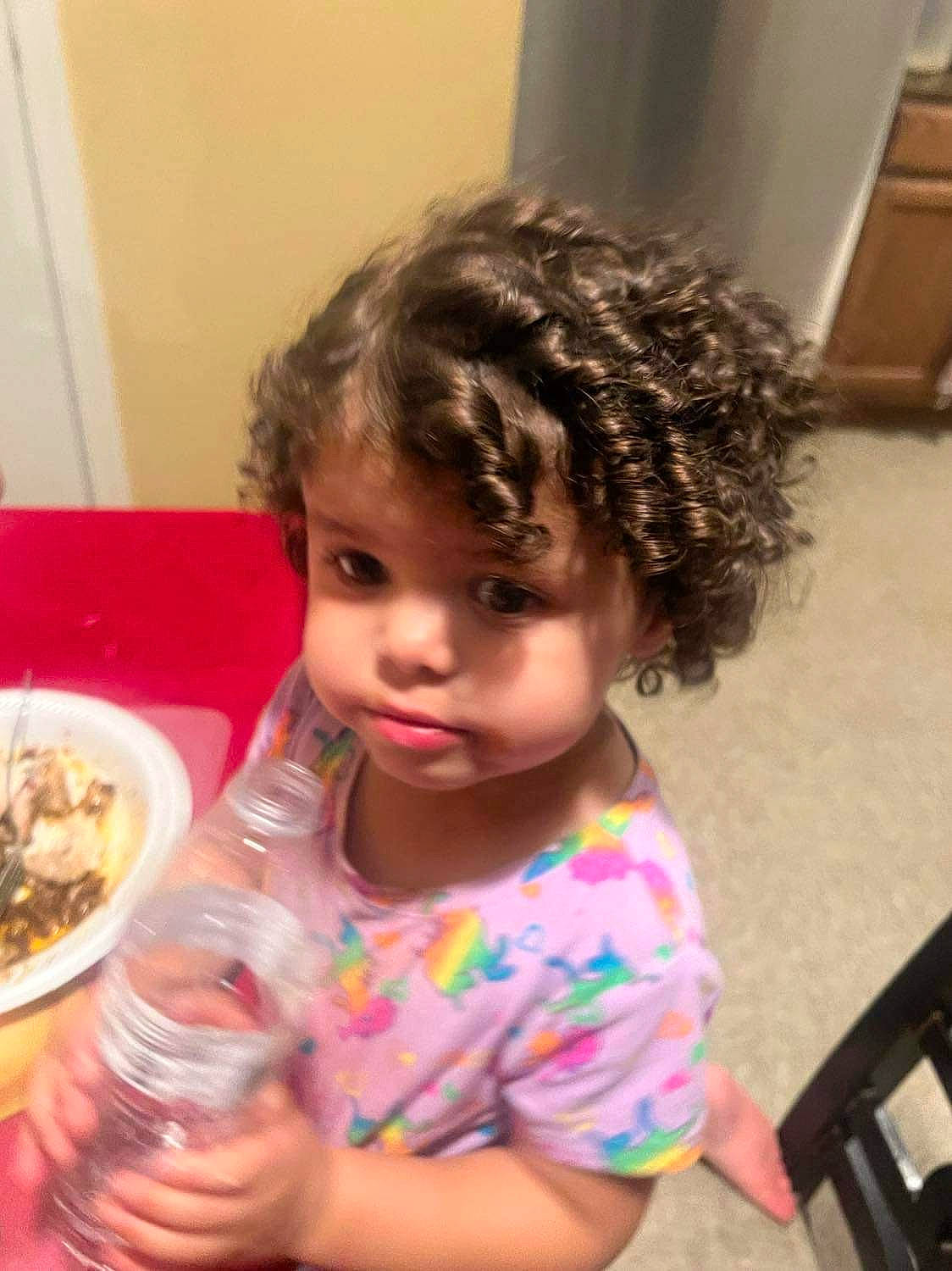 Penelope is registered to the contest to win money with this photo: baby, breakfast, cheek, child, comfort_food, drinking_water, drinkware, flooring, food, fun, happy, meal, person, plate, play, ringlet, skin, sweetness, tableware, toddler