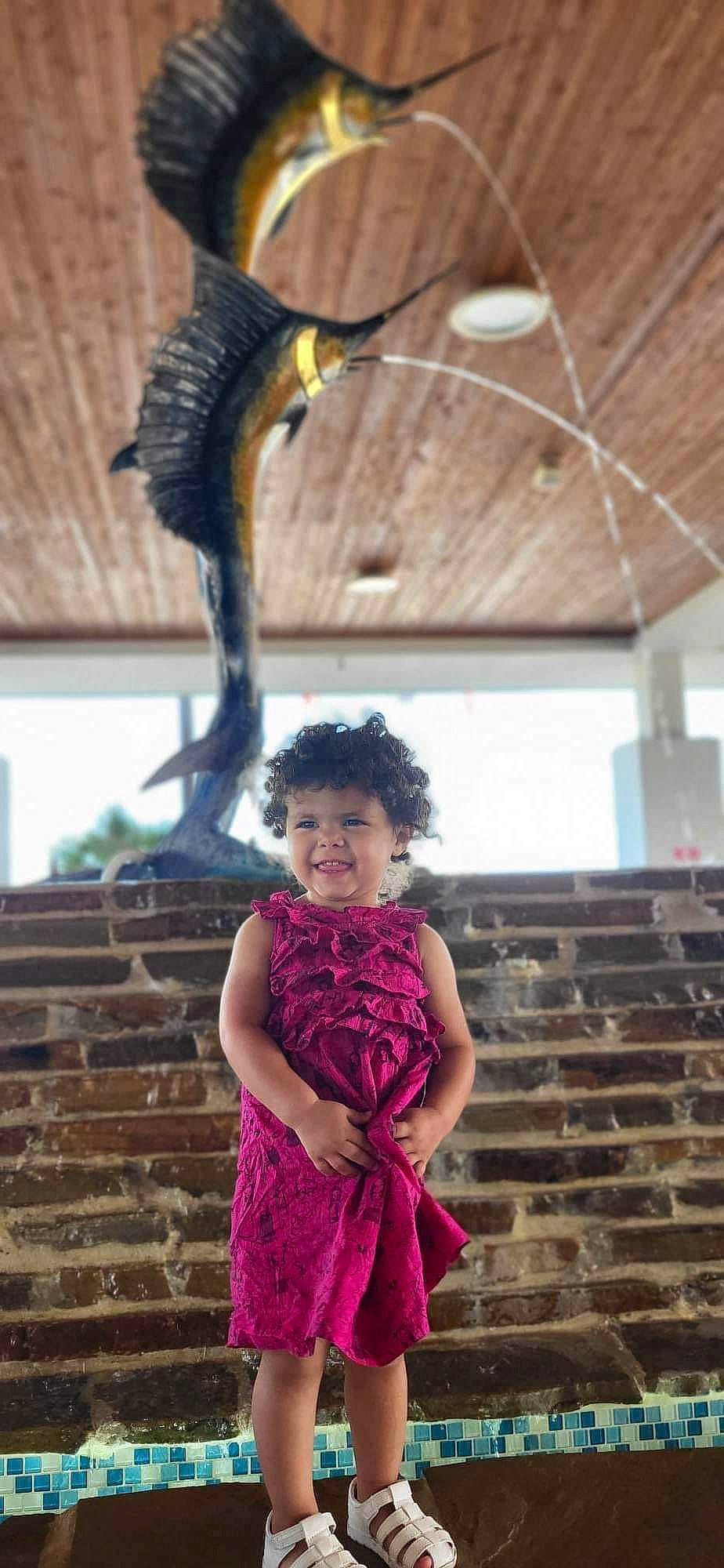 Penelope is registered to the contest to win money with this photo: beak, bird, costume, event, fashion_accessory, fashion_design, feather, fun, fur, hairstyle, happy, joy, leisure, magenta, person, piciformes, snapshot, tail, toddler, tradition