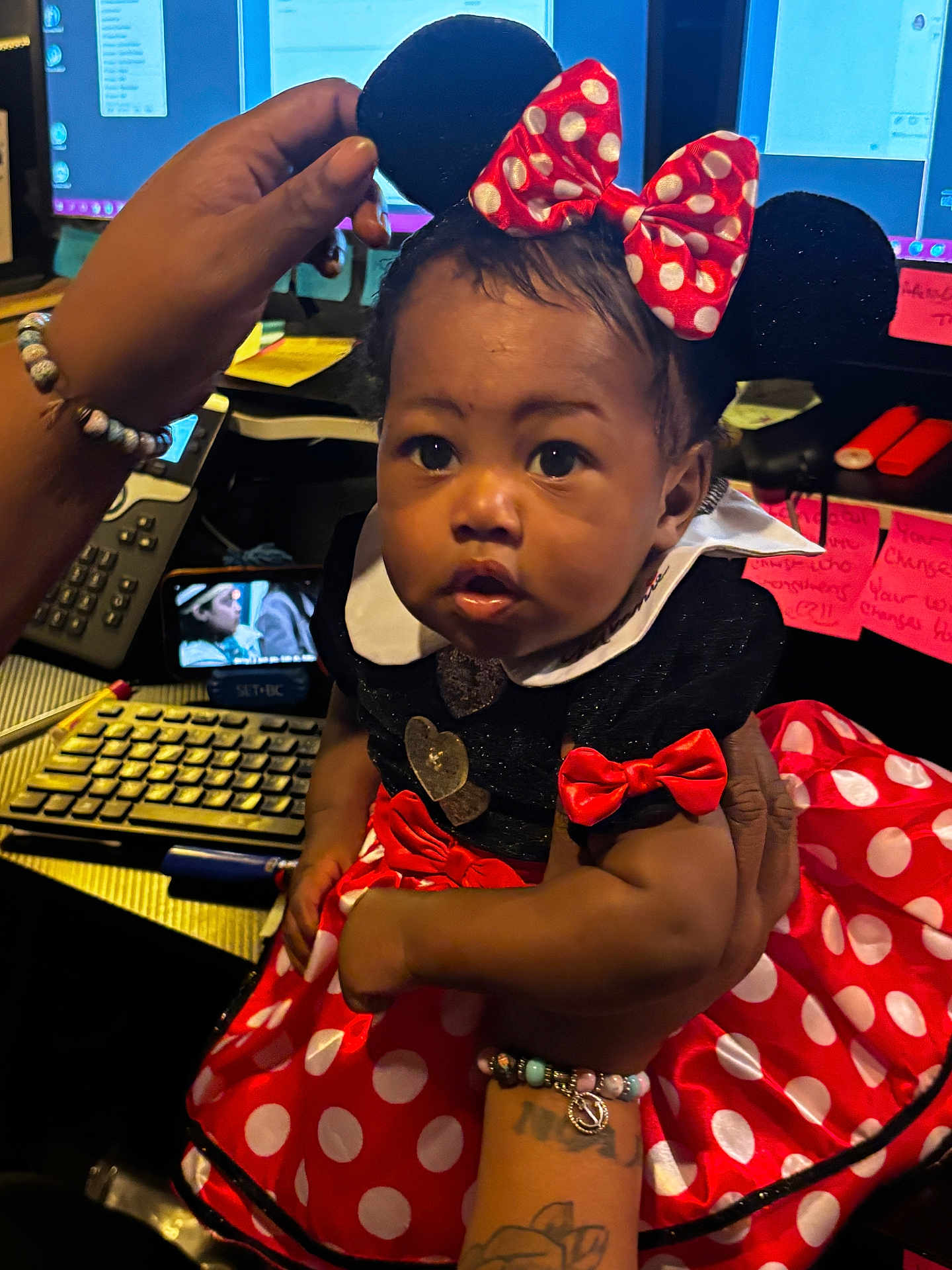 Ra'Mairie joined the competition — help win amazing prizes! baby, child, minnie_mouse, costume, red_bow, polka_dots, dress, hand, bracelet, tattoo, office, keyboard, computer_screen, sticky_notes, person, portrait, cute, indoor, young_child, face