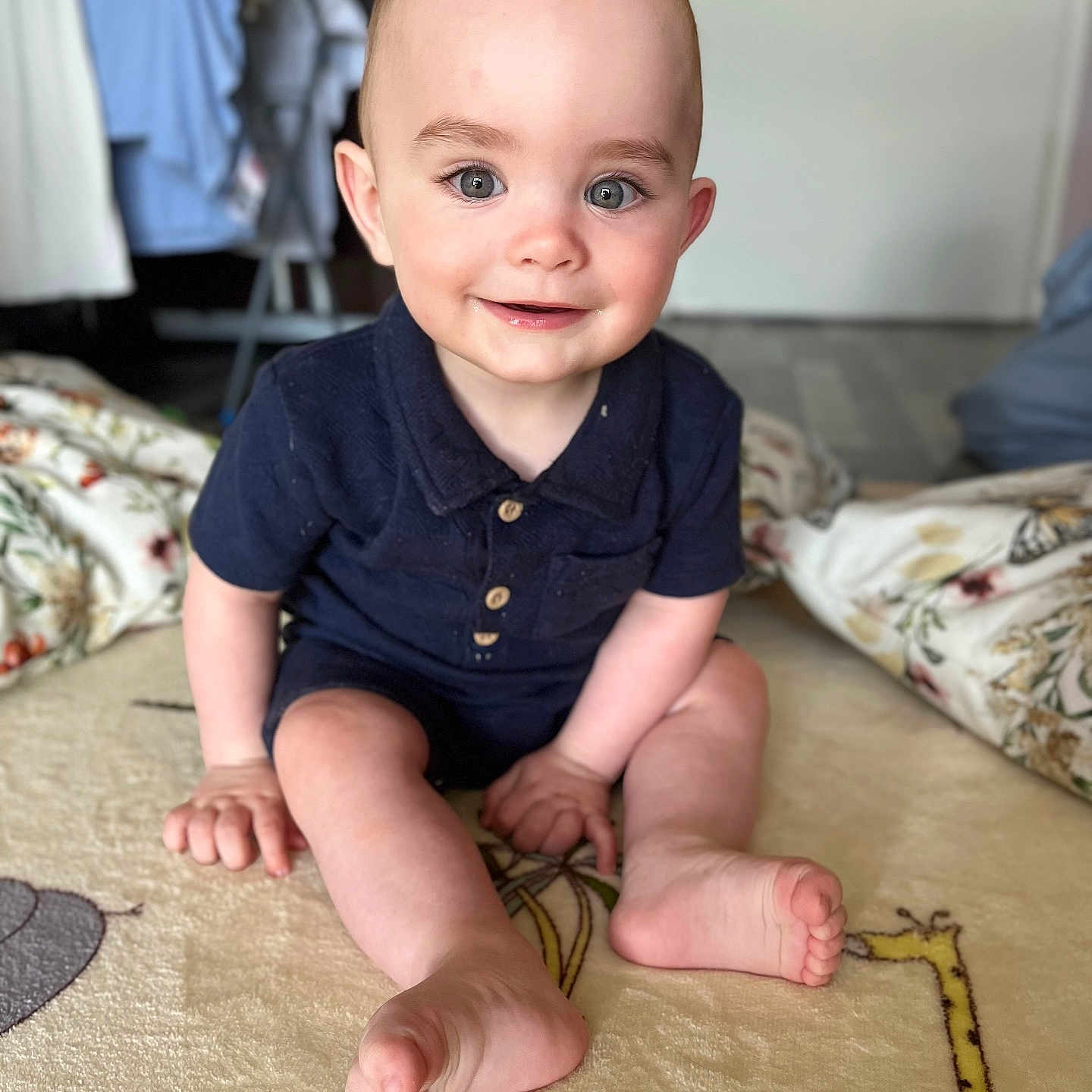 Bohdi-Bleu is registered to the contest to win money with this photo: baby, blanket, blue_outfit, carpet, child, clothing, cute, face, feet, floor, furniture, happy, home, indoor, infant, person, portrait, sitting, smiling, toddler