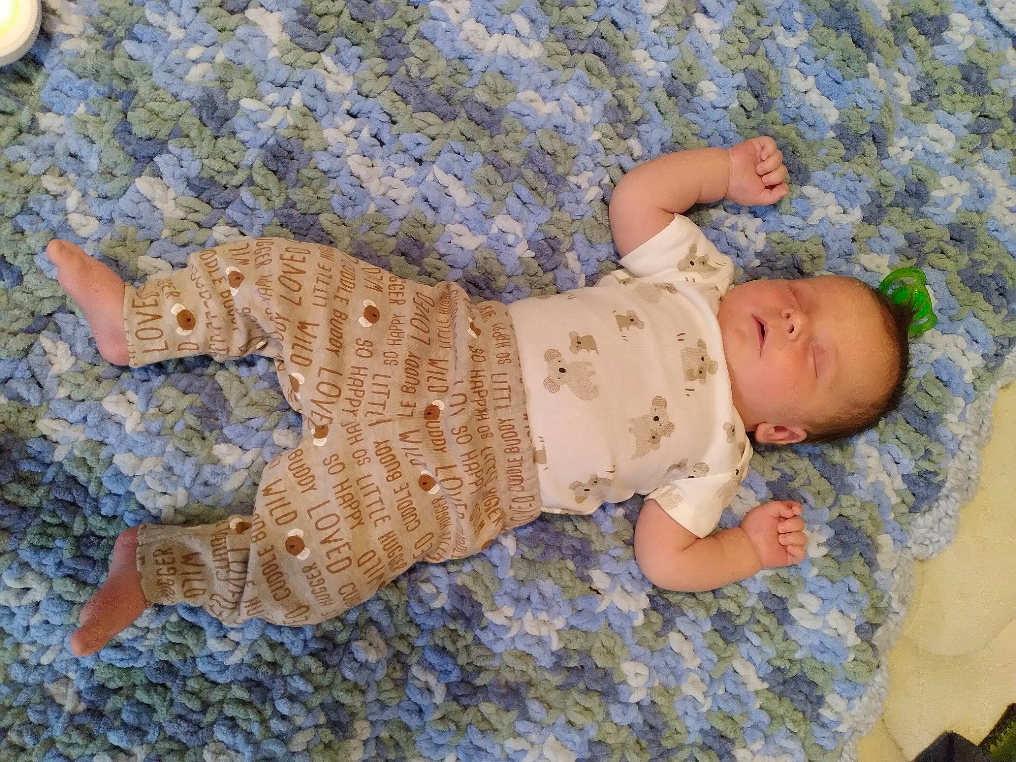 Donald is registered to the contest to win money with this photo: baby, baby_products, baby_sleeping, baby_toddler_clothing, child, comfort, craft, creative_arts, flooring, foot, grass, linens, pattern, person, play, sitting, skin, sleeve, textile, toddler