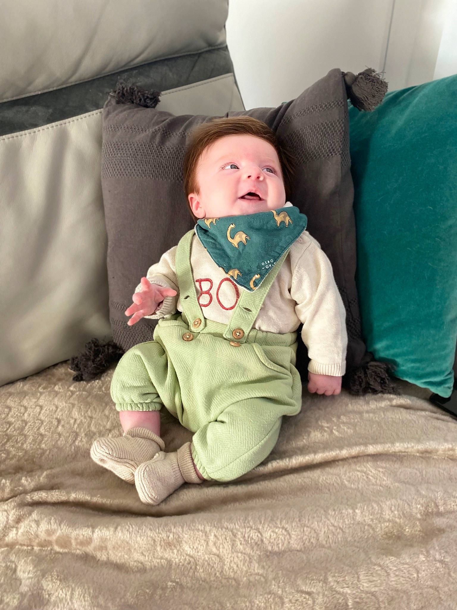 Gabriel participe au concours pour gagner de l'argent avec cette photo : baby, baby_toddler_clothing, cheek, child, comfort, couch, flooring, foot, fun, grass, lap, leg, linens, person, product, room, sitting, sleeve, sock, toddler