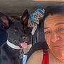 Luna is registered to the contest to win money with this photo: woman, dog, car, seat, black_dog, collar, smiling, sunlight, indoor, portrait, happy, person, animal, pet, ears, clothing, necklace, seatbelt, window, seat_cover