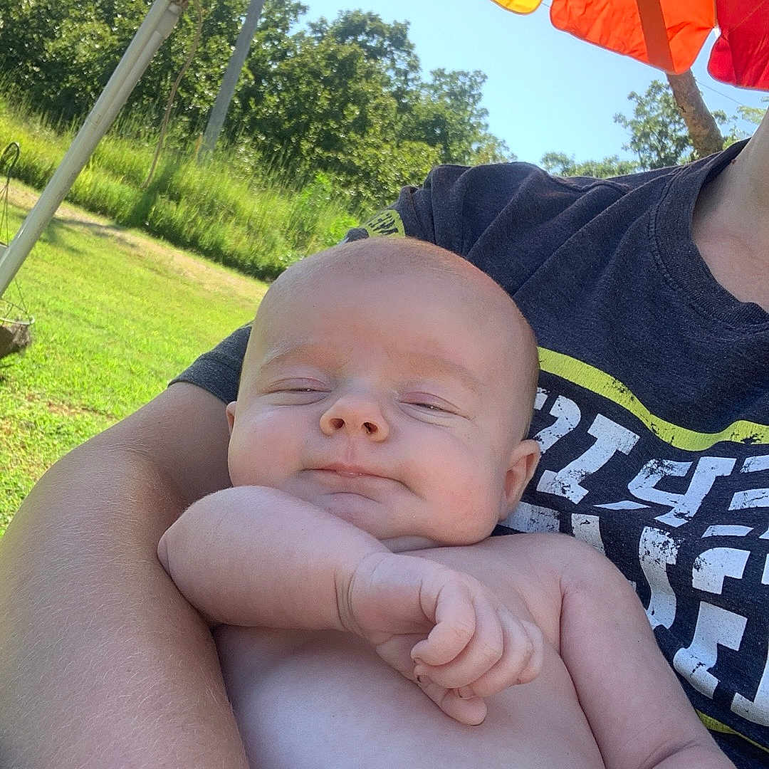 Bodhi joined the competition — help win amazing prizes! arm, baby, daylight, greenery, hand, holding, infant, nature, outdoor, peaceful, person, portrait, rainbow, relaxing, shirt, skin, smile, sunlight, tshirt, umbrella