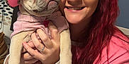 Hazel joined the competition — help win amazing prizes! woman, dog, pet, indoor, pink_clothing, hat, smile, red_hair, holding, cute, puppy, sweater, face, hand, human, fur, animal, friendship, joy, companion