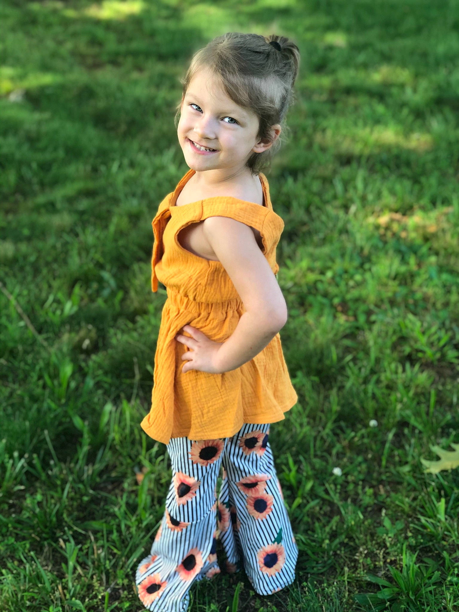 Aubree joined the competition — help win amazing prizes! baby_toddler_clothing, blond, brown_hair, child, child_model, day_dress, dress, grass, grass_family, happy, human, human_body, joy, meadow, mouth, nose, one_piece_garment, people_in_nature, person, prairie