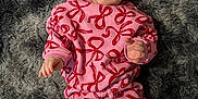 Sienna joined the competition — help win amazing prizes! baby, child, smiling, headband, bow, pink_clothing, red_clothing, patterned_clothing, lying_down, rug, fluffy_rug, happy, cute, infant, person, portrait, indoors, soft_texture, cozy, bright_colors