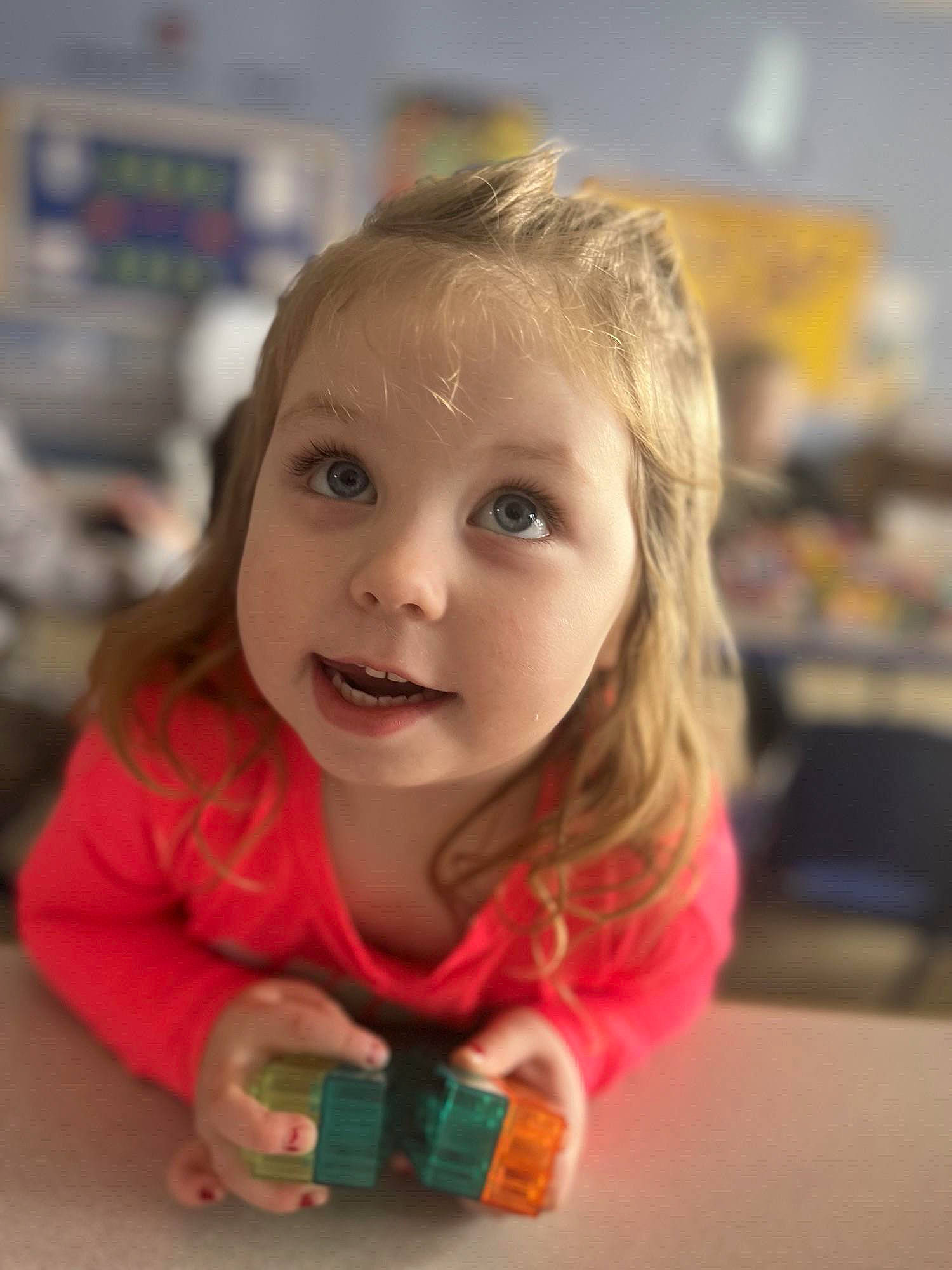 Harley is registered to the contest to win money with this photo: cheek, child, eye, flooring, fun, happy, iris, kindergarten, leisure, nose, person, play, portrait_photography, recreation, room, sitting, skin, surprise, toddler, toy