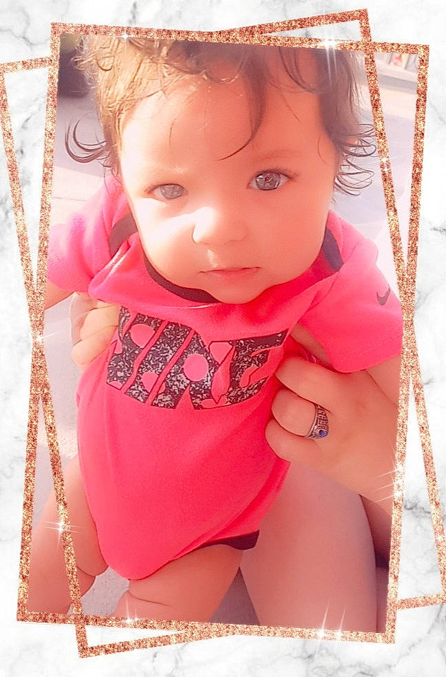 Noelle is registered to the contest to win money with this photo: baby_toddler_clothing, beauty, cheek, chest, child, eyelash, finger, happy, lip, magenta, neck, pattern, person, pink, product, skin, sleeve, sun_hat, textile, thigh