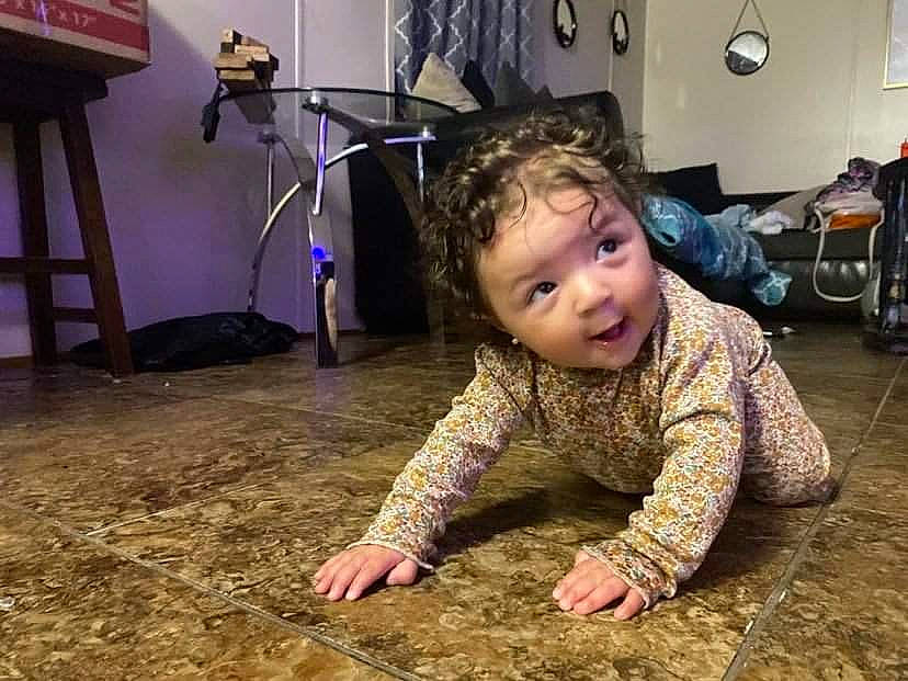 Noelle joined the competition — help win amazing prizes! baby, baby_toddler_clothing, backpack, carpet, chair, child, comfort, crawling, floor, flooring, fun, hardwood, military_camouflage, person, room, sitting, smile, soil, toddler, wood