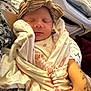 Josie is registered to the contest to win money with this photo: newborn, baby, sleeping, blanket, headband, tattoo, arm, closeup, soft, wrapped, cute, pattern, indoor, person, infant, peaceful, resting, human, skin, clothing