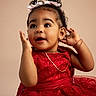 toddler, child, girl, red_dress, lace, hair_bows, portrait, cute, smiling, earrings, chain_necklace, curly_hair, studio, indoor, fashion, expression, hands_up, young_child, innocent, adorable