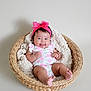 baby, infant, smiling, basket, blanket, headband, pink_bow, floral_outfit, cute, happy, indoors, soft_texture, child, portrait, newborn, cozy, resting, skin, feet, hands