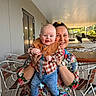 Rían joined the competition — help win amazing prizes! baby, child, woman, smiling, holding, outdoor, cafe, table, chair, clothing, jeans, bib, happy, person, portrait, daylight, metal, wood, watch, accessory