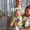 Rían is registered to the contest to win money with this photo: adult, baby, casual_clothing, child, curtain, cute, family, flower_basket, happy, holding, home, indoor, love, parent, people, portrait, smiling, striped_shirt, toddler, warm