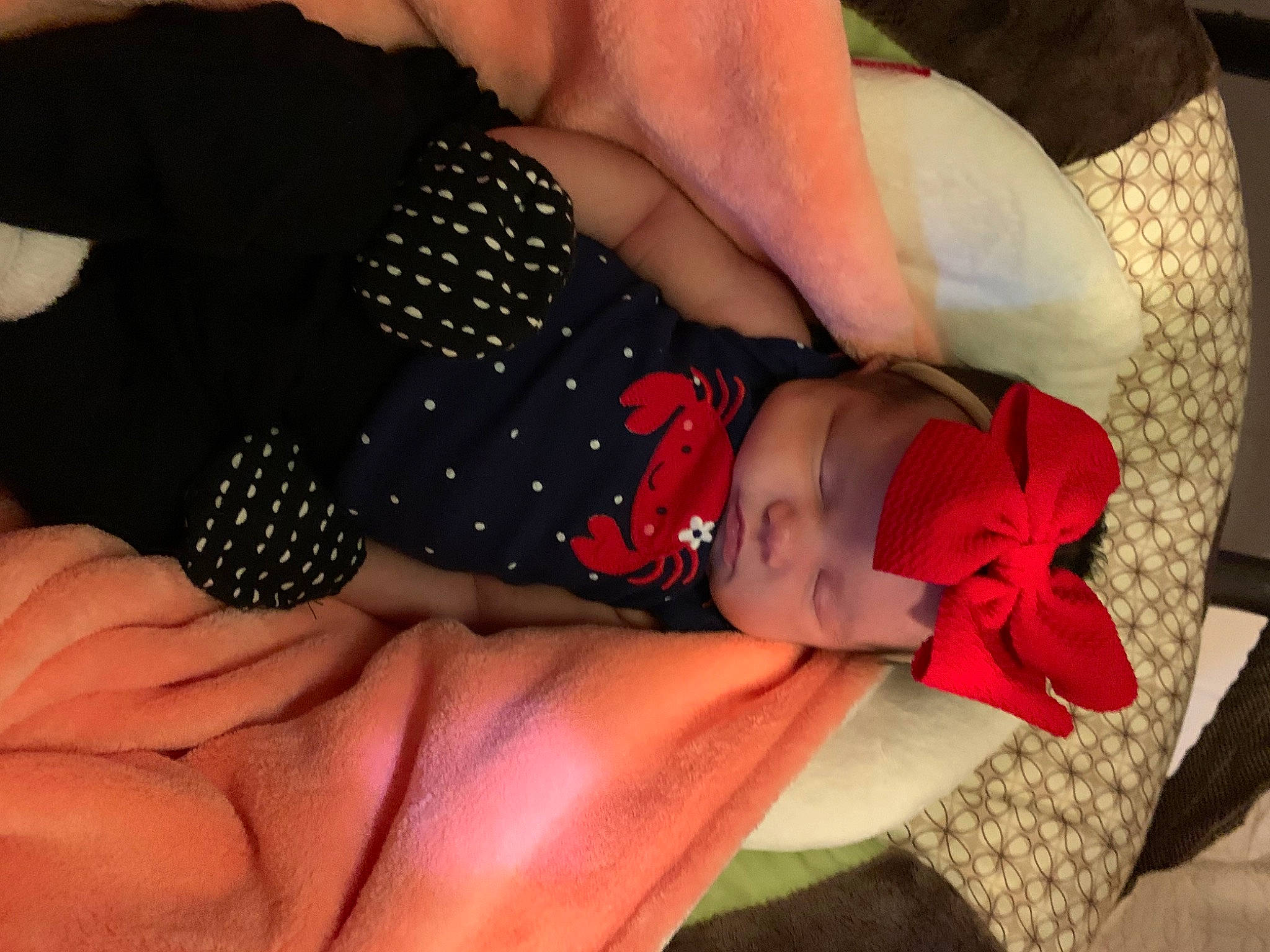 Madison is registered to the contest to win money with this photo: arm, baby, baby_products, baby_sleeping, baby_toddler_clothing, child, comfort, finger, gesture, hand, headwear, human_body, human_leg, linens, nail, pattern, person, sunglasses, textile, thigh