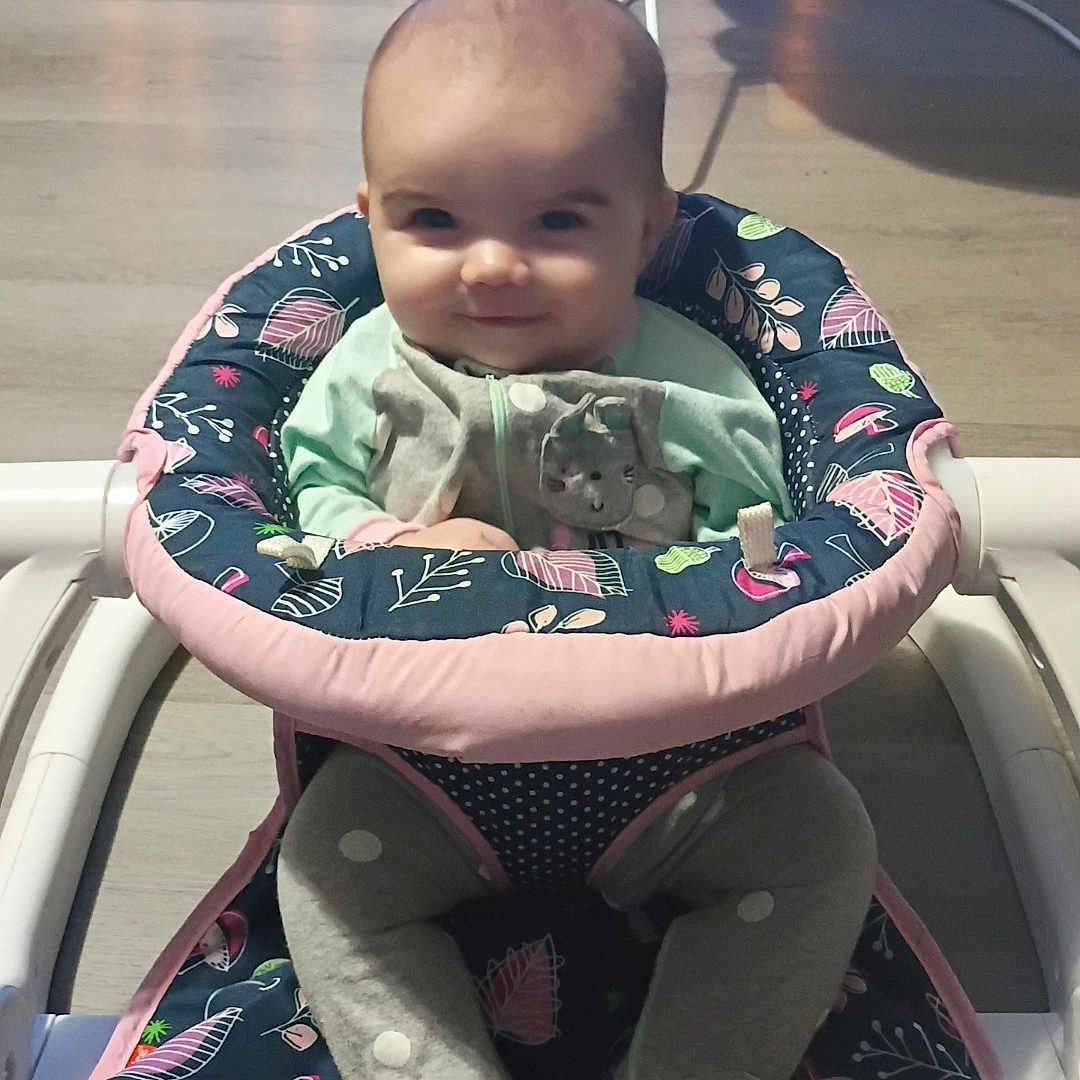 Octavia is registered to the contest to win money with this photo: baby, child, clothing, cute, floor, footwear, furniture, happy, home, indoor, infant, legs, pattern, person, playtime, seat, smiling, toy, walker, young