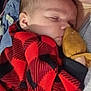 baby, sleeping, infant, red_clothing, plaid, mitten, close_up, person, cuddle, toddler, cozy, soft, peaceful, indoor, portrait, young_child, fabric, bedroom, rest, comfort