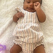 Angie joined the competition — help win amazing prizes! baby, infant, child, striped_clothing, blanket, soft_texture, lying_down, cute, cozy, sleepy, hand, face, legs, skin, indoors, comfortable, resting, young, person, portrait