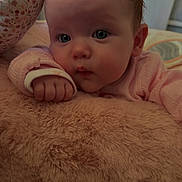 Priscilla joined the competition — help win amazing prizes! baby, infant, face, hand, pink_clothing, soft_texture, fluffy, closeup, portrait, child, cute, sleepwear, skin, resting, indoors, young, curious, cozy, comfort, expression