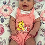 baby, infant, smiling, romper, headband, flower, cushion, floral_pattern, pink, white, socks, cute, happy, child, person, portrait, indoors, soft_lighting, clothing, resting
