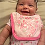 Sienna joined the competition — help win amazing prizes! baby, smile, headband, bib, pink, floral, clothing, infant, cute, happy, lying_down, face, skin, person, apparel, child, indoors, closeup, young, adorable