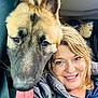 blond_hair, car_interior, closeup, companion, dog, ears, eyes, face, fur, happy, indoors, jacket, person, pet, portrait, seatbelt, smile, tongue, tongue_out, window