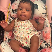 Zoie joined the competition — help win amazing prizes! baby, infant, child, car_seat, floral_pattern, clothing, person, face, arms, legs, pink, white, comfort, relaxation, indoors, cute, young_child, seat, portrait, infant_clothing