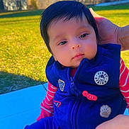 Yaman is registered to the contest to win money with this photo: baby, blue_sky, casual_wear, child, clothing, cute, daytime, grass, hand, infant, nature, outdoor, patches, person, portrait, sitting, sunlight, support, trees, vest