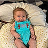 baby, infant, smile, romper, turquoise_clothing, polka_dot_pillow, nursing_pillow, indoor, cute, chubby_cheeks, person, face, happy, sitting, bedroom, pillow, child, young_baby, clothing, mischievous