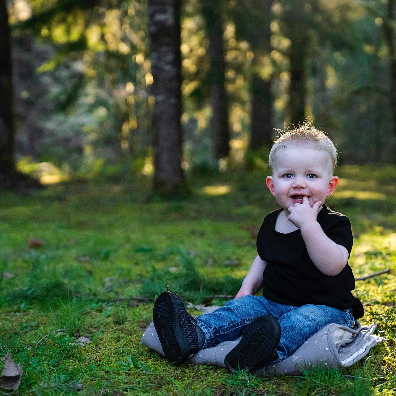 Lane joined the competition — help win amazing prizes! bodypart, boy, child, clothing, face, finger, footwear, grass, hand, head, jeans, pants, person, photography, plant, portrait, shoe, sitting, tree, vegetation