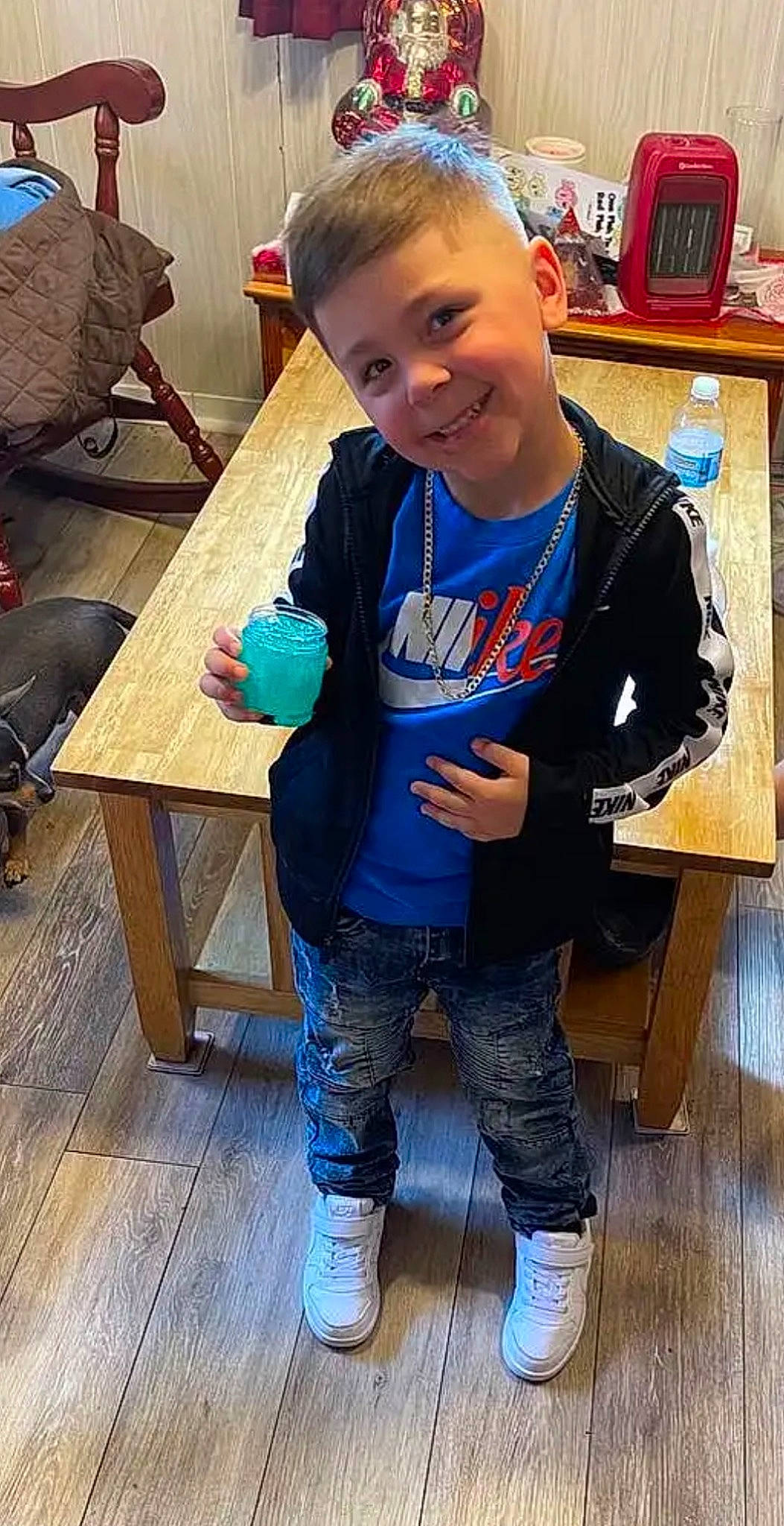 Jose is registered to the contest to win money with this photo: child, denim, electric_blue, engineering, flooring, fun, happy, hardwood, joint, joy, leisure, person, play, sitting, sleeve, smile, standing, t_shirt, table, thumb