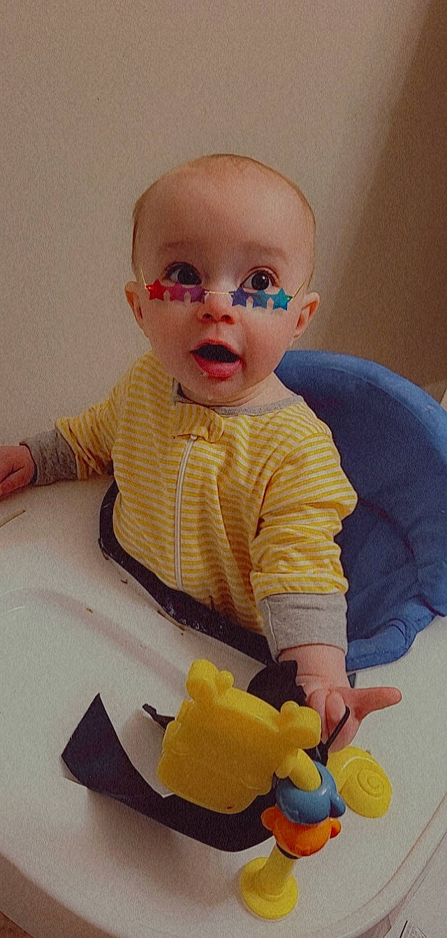 Noah is registered to the contest to win money with this photo: baby, baby_playing_with_toys, baby_products, baby_safety, baby_toddler_clothing, baby_toys, cheek, comfort, finger, fun, happy, head, human_body, person, sitting, sleeve, surprise, t_shirt, tableware, toddler