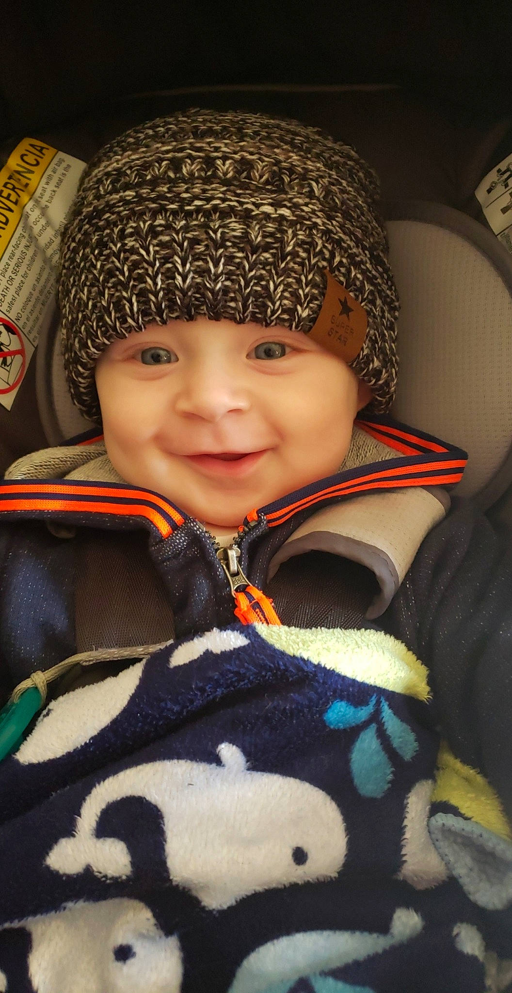 Sylas is registered to the contest to win money with this photo: beanie, bonnet, cap, cheek, child, cool, eye, eyebrow, face, forehead, head, headgear, headwear, joy, knit_cap, knitting, nose, person, smile, toddler