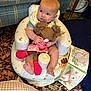 baby, infant, child, doll, inflatable_seat, toy, smiling, sitting, feet, hands, patterned_rug, couch, living_room, soft_book, plush_toy, bib, clothing, head, portrait, cozy