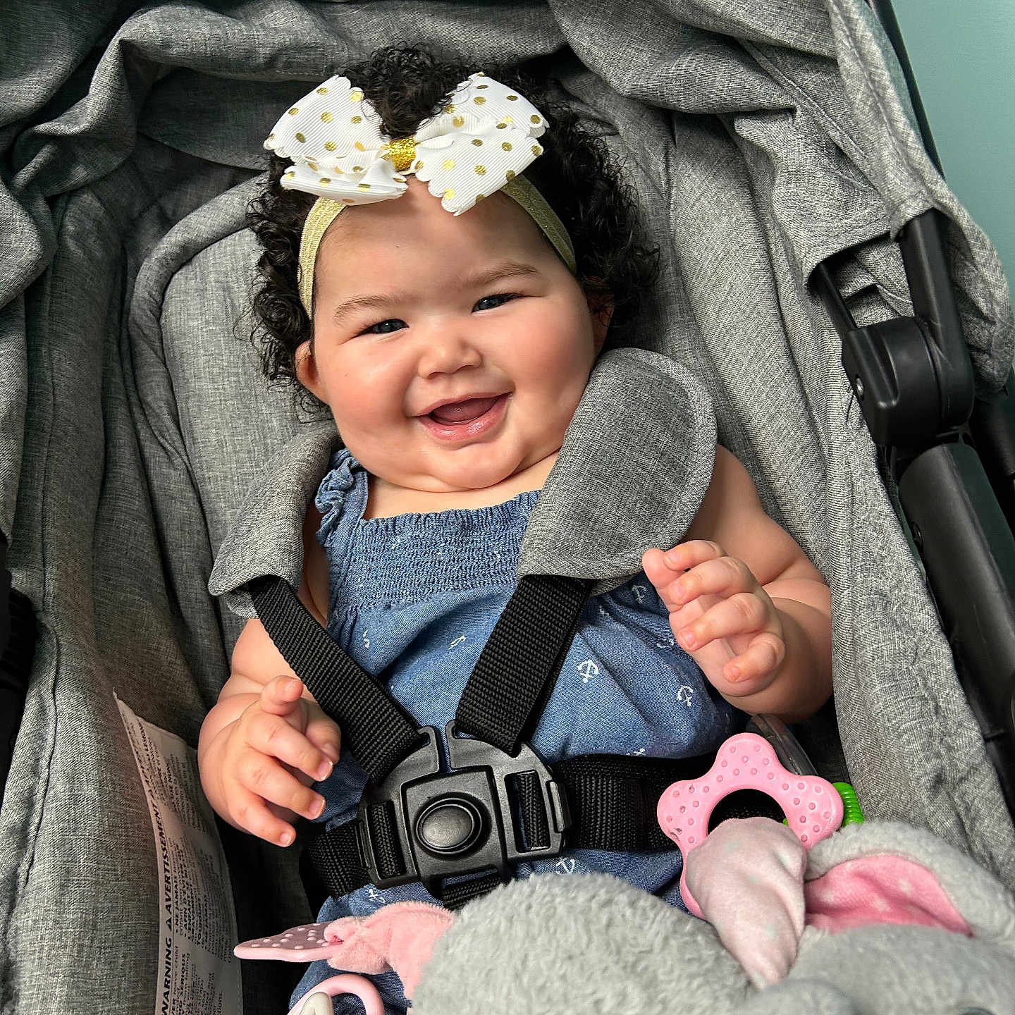 Kinsley is registered to the contest to win money with this photo: accessories, baby, bodypart, clothing, coat, face, finger, hand, happy, hat, head, jacket, laughing, pants, person, photography, portrait, smile, strap, stroller