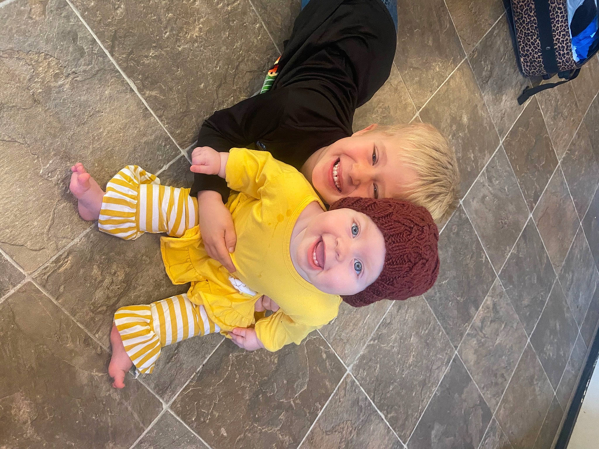 Gracelyn is registered to the contest to win money with this photo: baby, baby_toddler_clothing, child, concrete, floor, flooring, fun, grass, happy, hat, headwear, joy, orange, pattern, person, play, road_surface, sidewalk, sitting, smile