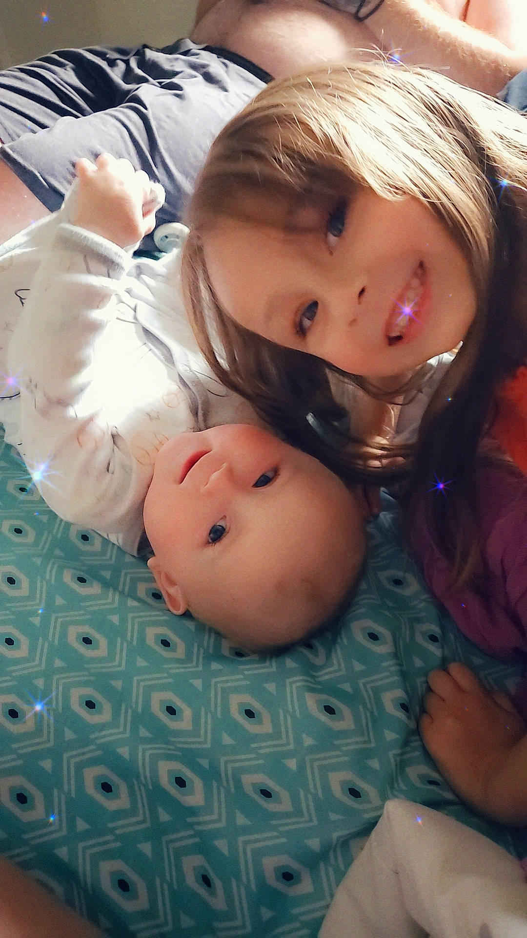 Emery is registered to the contest to win money with this photo: baby, baby_toddler_clothing, bangs, cheek, child, eye, eyelash, face, fun, gesture, happy, head, iris, joy, lip, mouth, nose, pattern, person, skin