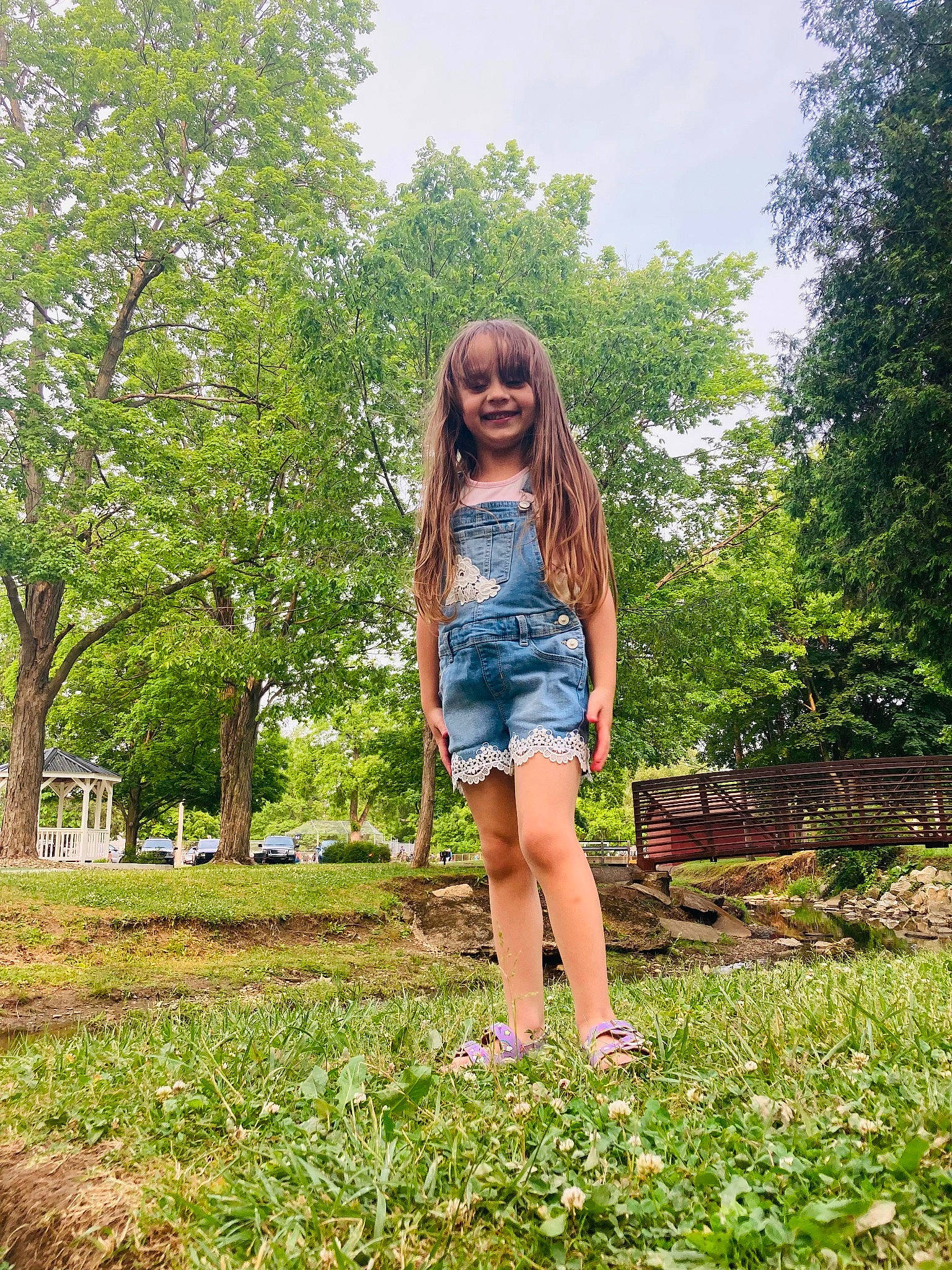 Emery is registered to the contest to win money with this photo: botany, brown_hair, denim, electric_blue, fun, grass, grassland, happy, human_leg, joy, knee, leisure, long_hair, people_in_nature, person, plant, recreation, sky, summer, thigh