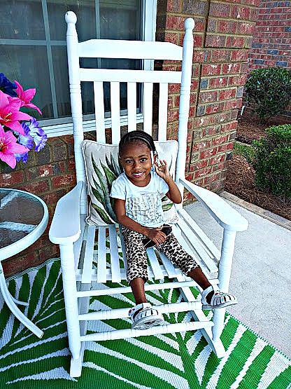 Kalia is registered to the contest to win money with this photo: backyard, chair, child, furniture, grass, home, house, joy, leisure, outdoor_furniture, person, plant, porch, summer, tree, vacation, white, yard