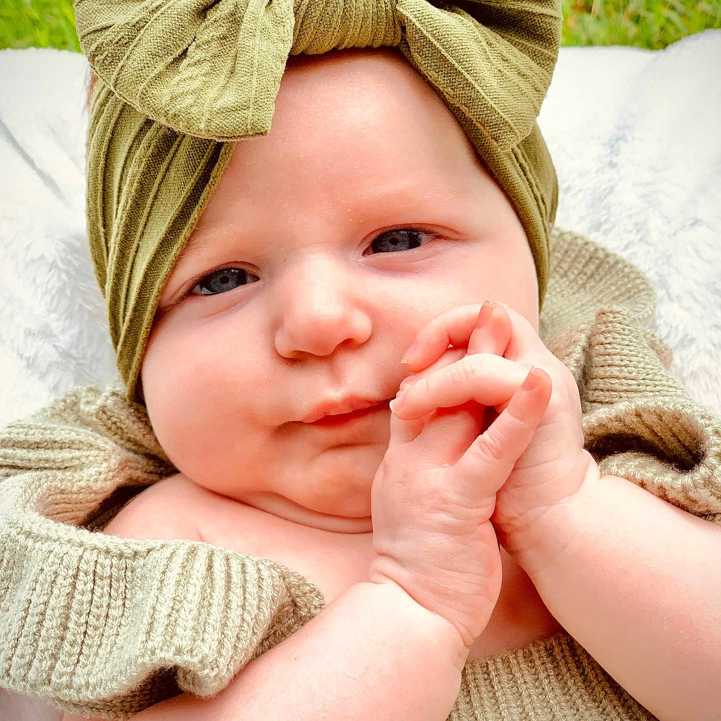 Renlei is registered to the contest to win money with this photo: accessories, baby, blanket, bodypart, bonnet, bracelet, cap, clothing, face, finger, hand, happy, hat, head, newborn, person, photography, portrait, smile, turban