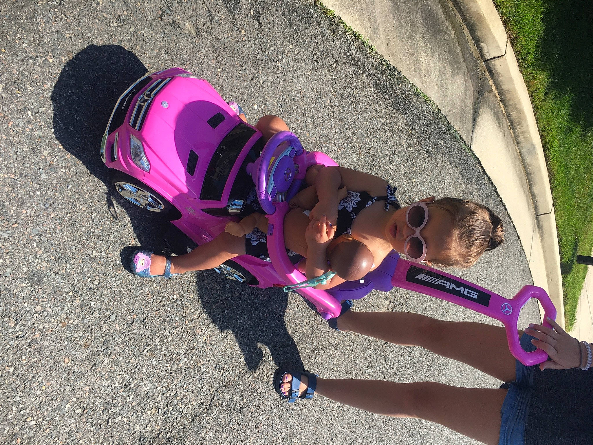 Gianna Marie joined the competition — help win amazing prizes! asphalt, auto_part, automotive_tire, automotive_wheel_system, child, electric_blue, eyewear, fashion_accessory, fun, grass, helmet, leisure, magenta, person, personal_protective_equipment, pink, recreation, tire, toddler, tree