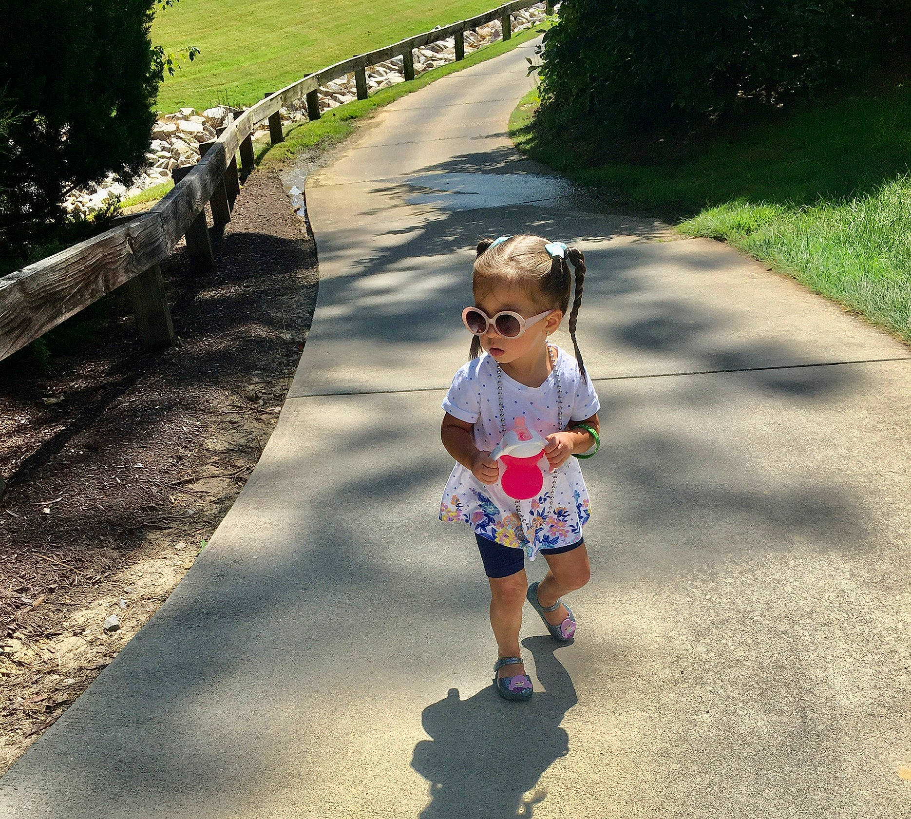 Gianna Marie is registered to the contest to win money with this photo: asphalt, baby_toddler_clothing, dress, gesture, grass, happy, leaf, leisure, people_in_nature, person, plant, public_space, recreation, road, road_surface, sidewalk, sleeve, sunlight, tints_and_shades, toddler