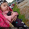 Violet is registered to the contest to win money with this photo: baby, blanket, headband, infant, outdoor, car, gravel, person, child, clothing, hand, grass, vehicle, holding, pink, black, white, face, cute, curious
